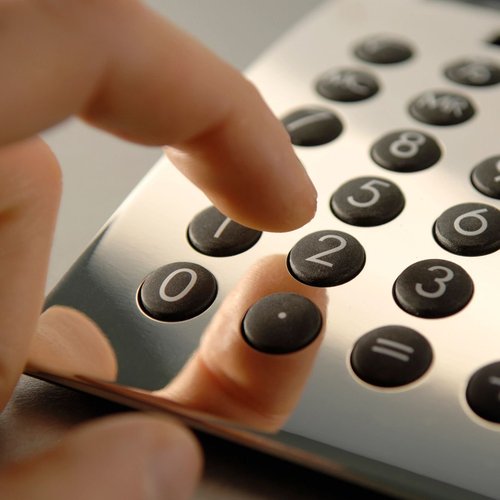 closeup of a person using a calculator