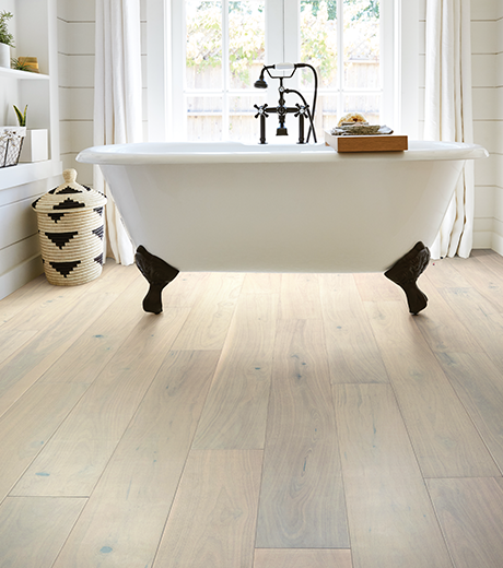 standalone white tub on vinyl flooring