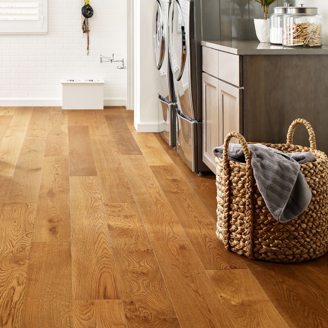 laundry area with hardwood floors