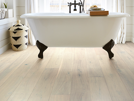 standalone white tub on vinyl flooring