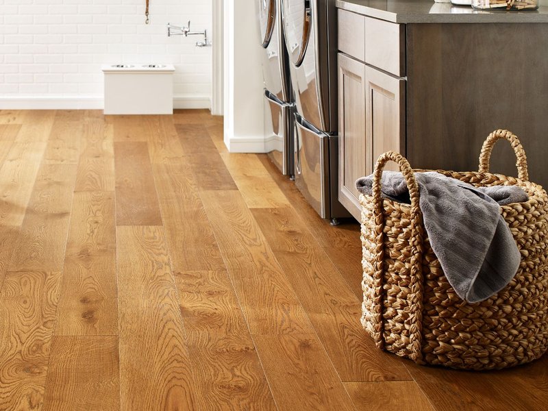 laundry area with hardwood floors