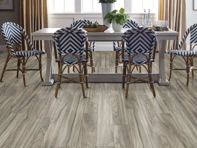 blue woven dining chairs around a dining table on laminate floors
