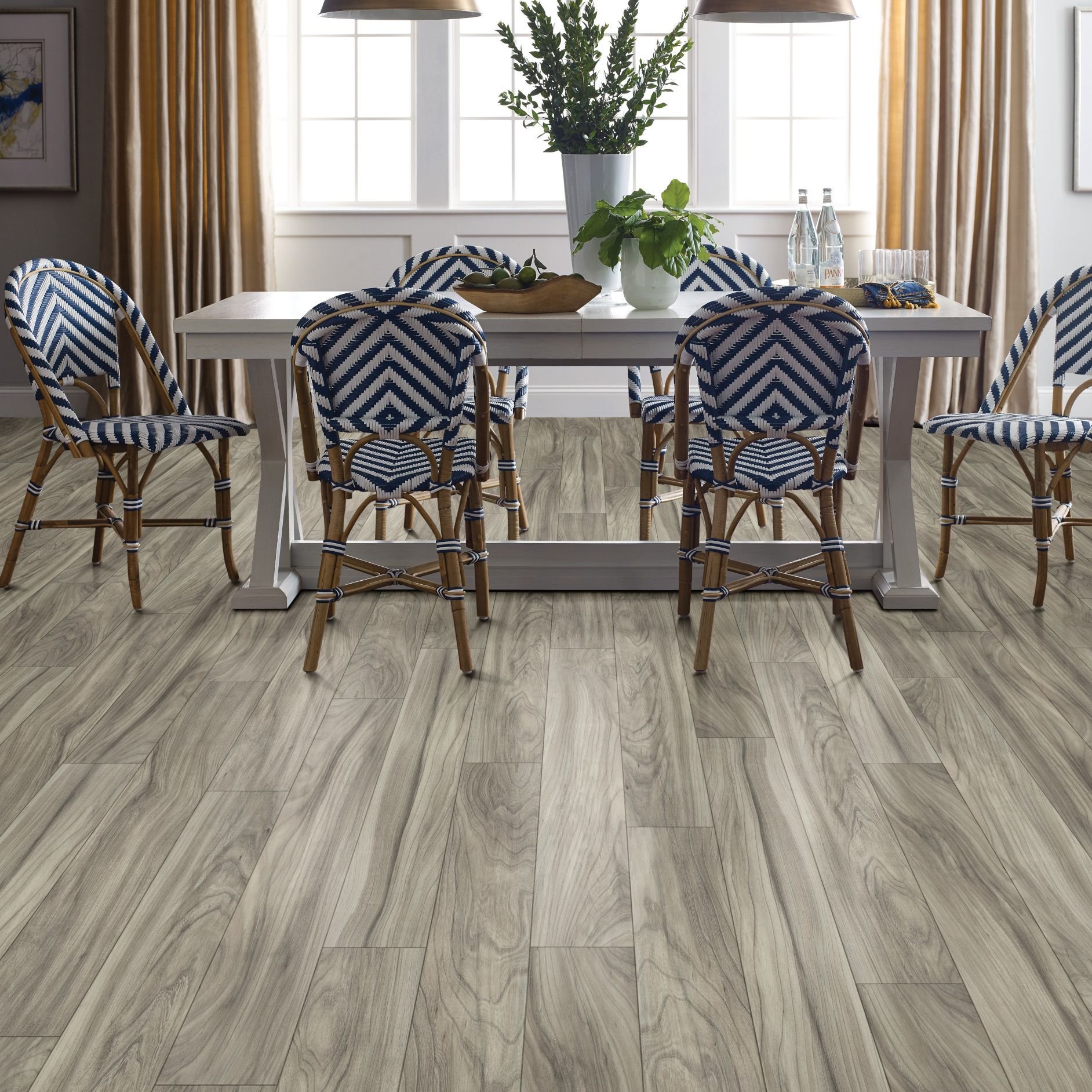 blue woven dining chairs around a dining table on laminate floors